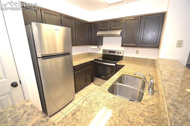 kitchen featuring sink, light tile patterned floors, dark brown cabinets, and appliances with stainless steel finishes