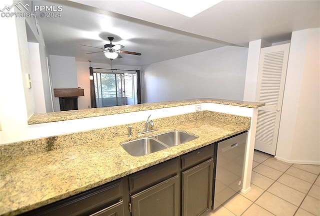 kitchen with light tile patterned flooring, dishwasher, sink, light stone counters, and ceiling fan