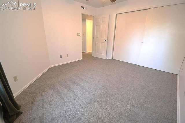 unfurnished bedroom featuring carpet and a closet