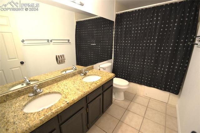 bathroom featuring tile patterned flooring, vanity, toilet, and walk in shower