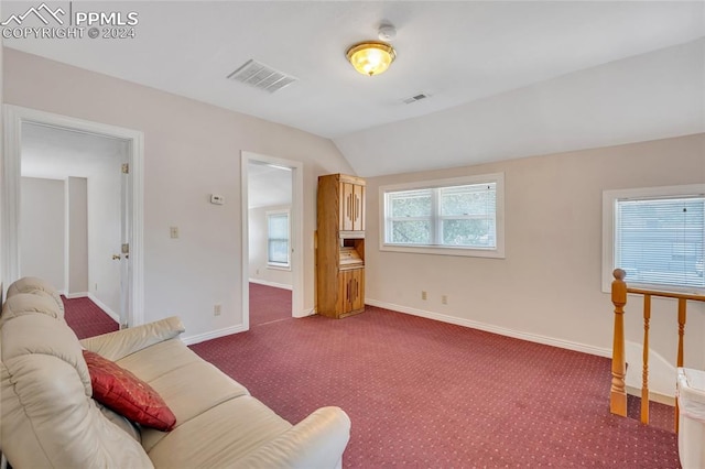 living room featuring carpet, a wealth of natural light, and lofted ceiling