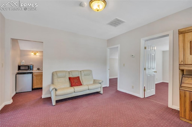 carpeted living room featuring sink