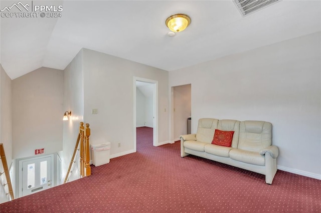 carpeted living room with vaulted ceiling