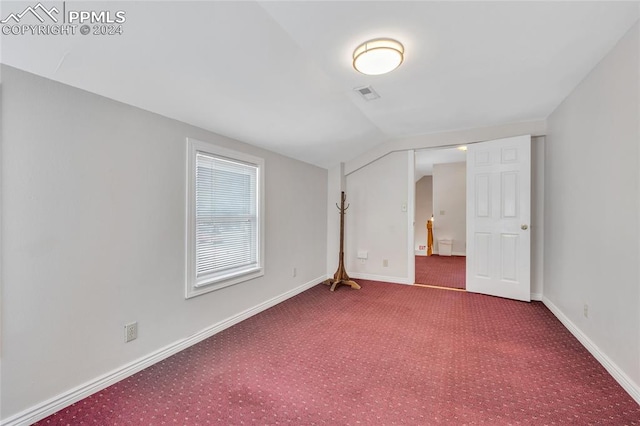 interior space with carpet floors and lofted ceiling