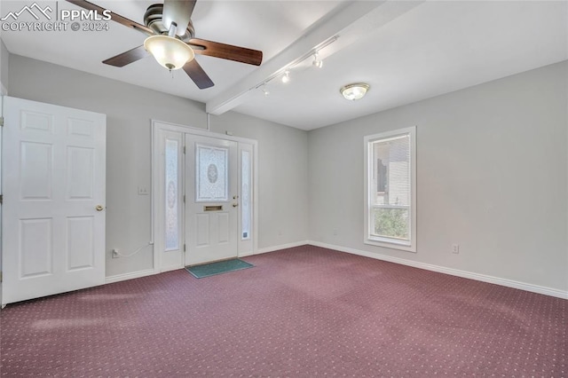 interior space featuring carpet flooring, beam ceiling, and ceiling fan