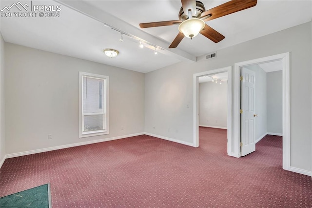 carpeted spare room featuring ceiling fan and rail lighting