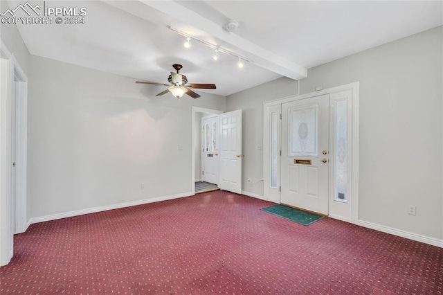 spare room featuring beamed ceiling, ceiling fan, and carpet floors