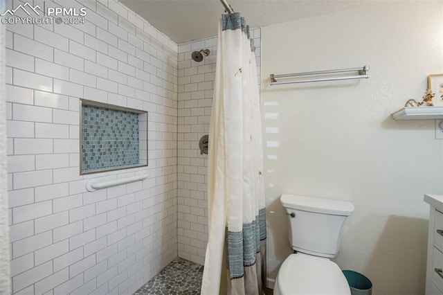 bathroom featuring vanity, toilet, and walk in shower