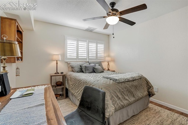 bedroom with ceiling fan and light hardwood / wood-style flooring