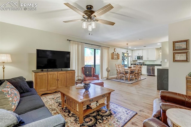 living room with ceiling fan and light hardwood / wood-style floors