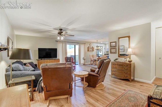 living room with ceiling fan and light hardwood / wood-style floors