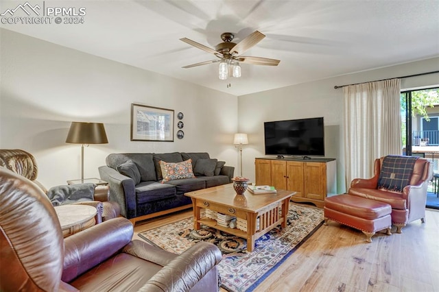 living room with ceiling fan and light wood-type flooring