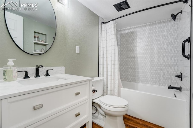 full bathroom featuring toilet, hardwood / wood-style floors, vanity, and shower / tub combo with curtain