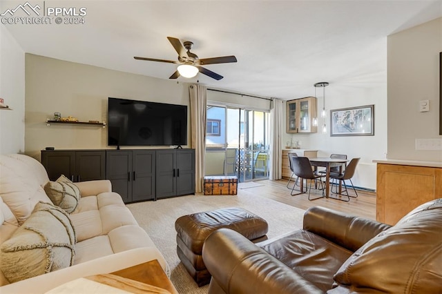 living room with ceiling fan and light wood-type flooring