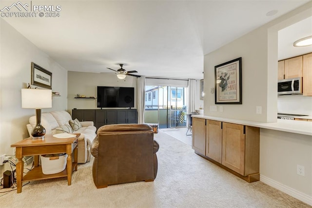 living room featuring light carpet and ceiling fan