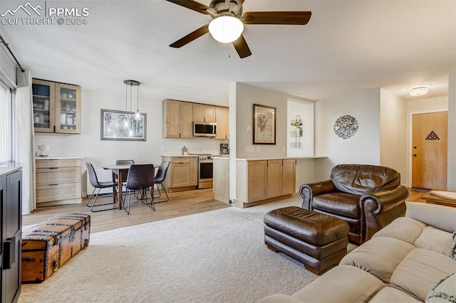 living room featuring ceiling fan and light wood-type flooring