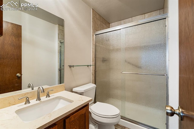 bathroom with vanity, toilet, and walk in shower