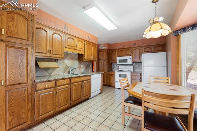 kitchen featuring white appliances, sink, light tile patterned floors, and tasteful backsplash