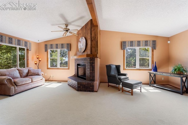 carpeted living room with ceiling fan, plenty of natural light, and vaulted ceiling