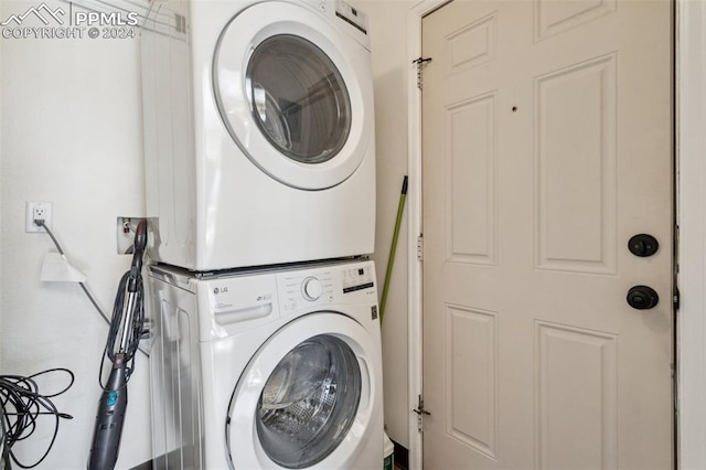 laundry room with stacked washing maching and dryer