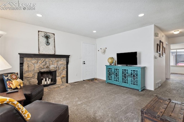 living room with a fireplace, carpet, and a textured ceiling