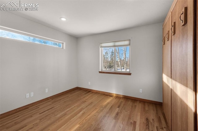 empty room with light hardwood / wood-style floors