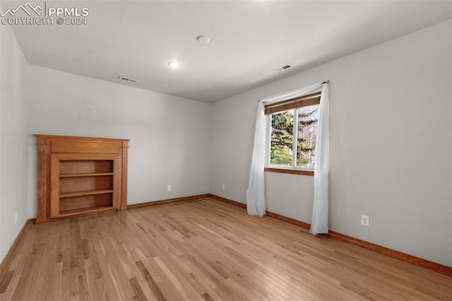 spare room featuring light hardwood / wood-style flooring