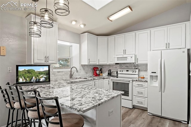 kitchen featuring white cabinetry, kitchen peninsula, pendant lighting, white appliances, and a breakfast bar