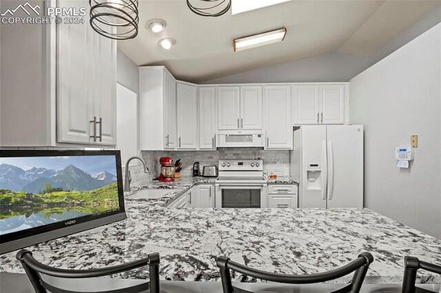 kitchen featuring backsplash, white appliances, vaulted ceiling, sink, and white cabinets