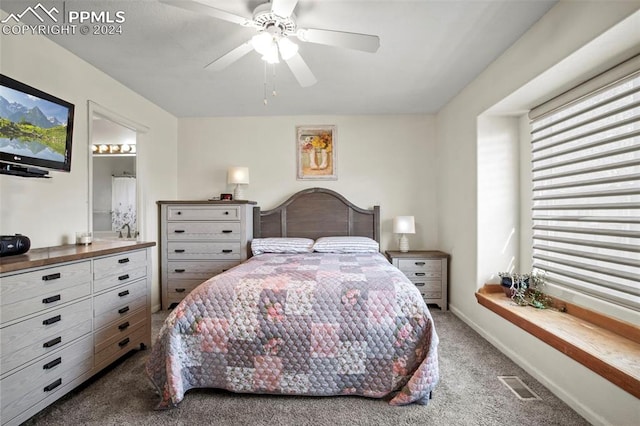 bedroom featuring carpet flooring, ceiling fan, and ensuite bathroom