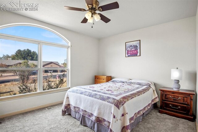 bedroom featuring ceiling fan and carpet