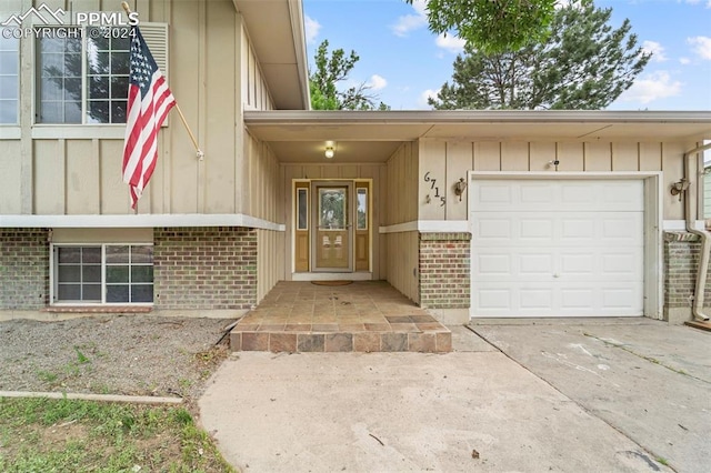 view of exterior entry with a garage