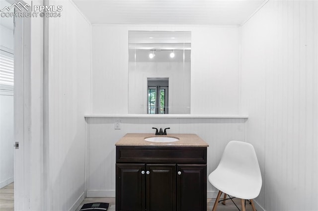 bathroom with wood walls and vanity