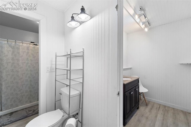 bathroom featuring wood-type flooring, vanity, and toilet