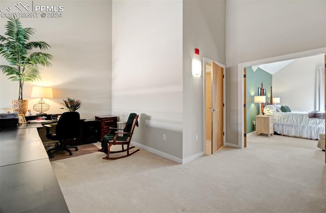 carpeted office featuring a high ceiling