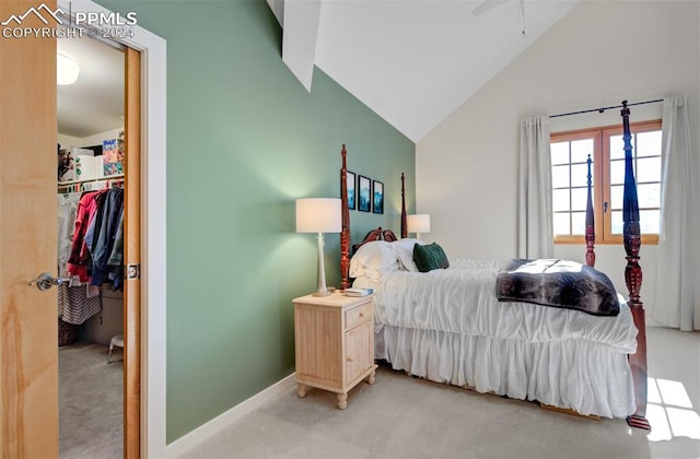 bedroom featuring a closet, light carpet, and vaulted ceiling