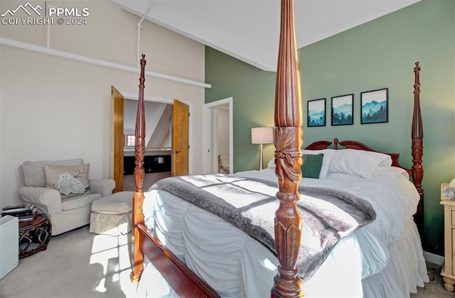 bedroom featuring light colored carpet and lofted ceiling