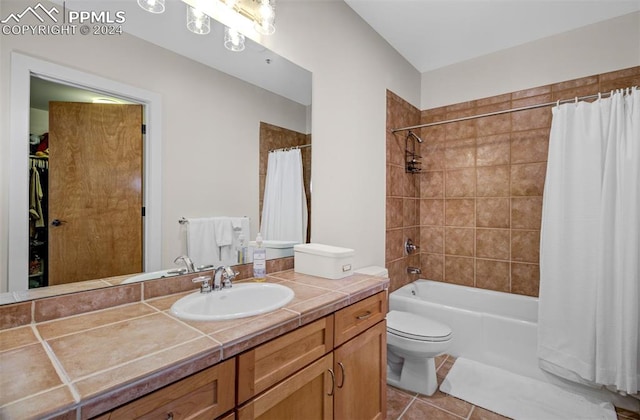 full bathroom featuring tile patterned flooring, vanity, shower / tub combo with curtain, and toilet