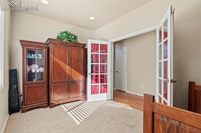 bedroom featuring light wood-type flooring and french doors