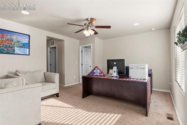 carpeted home office featuring plenty of natural light and ceiling fan