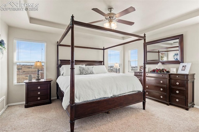 carpeted bedroom with ceiling fan and multiple windows