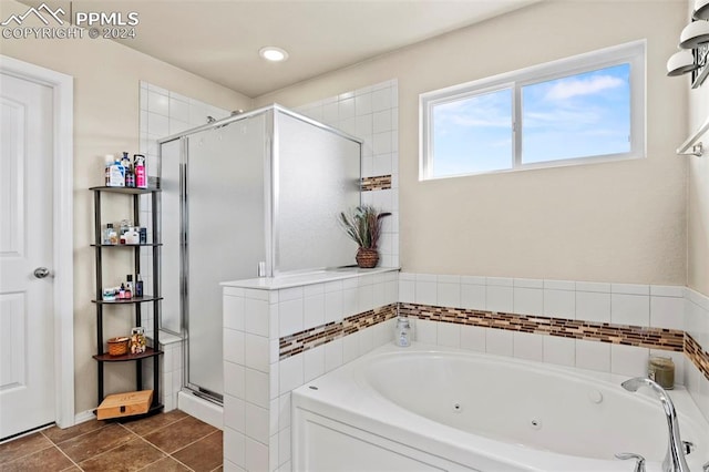 bathroom with tile patterned flooring and shower with separate bathtub