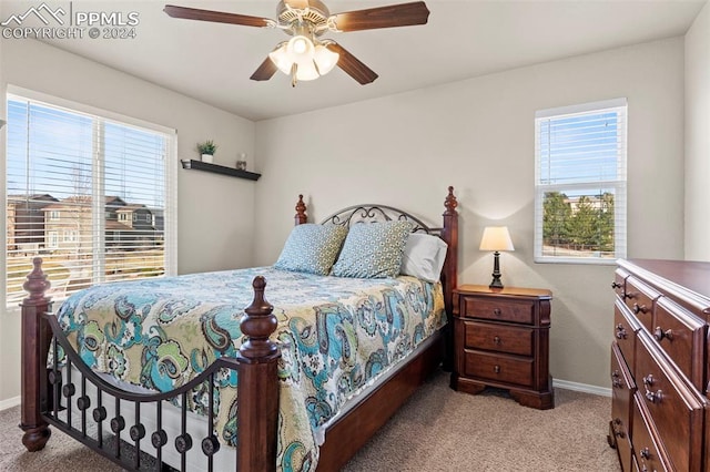 bedroom with light carpet and ceiling fan