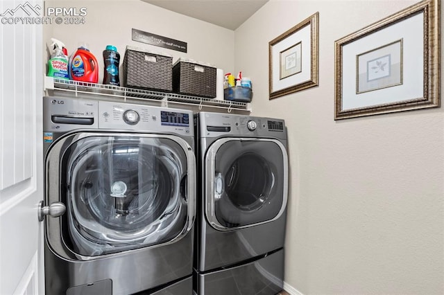 clothes washing area with independent washer and dryer