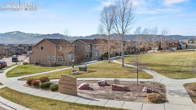 view of community with a mountain view and a yard