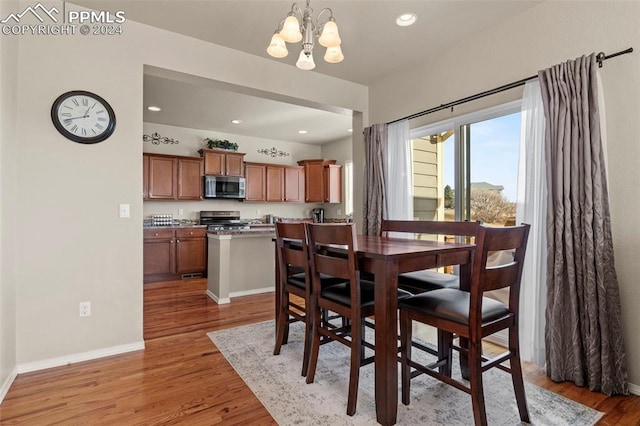 dining room featuring a chandelier and light hardwood / wood-style floors