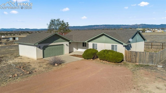 ranch-style house featuring a mountain view and a garage