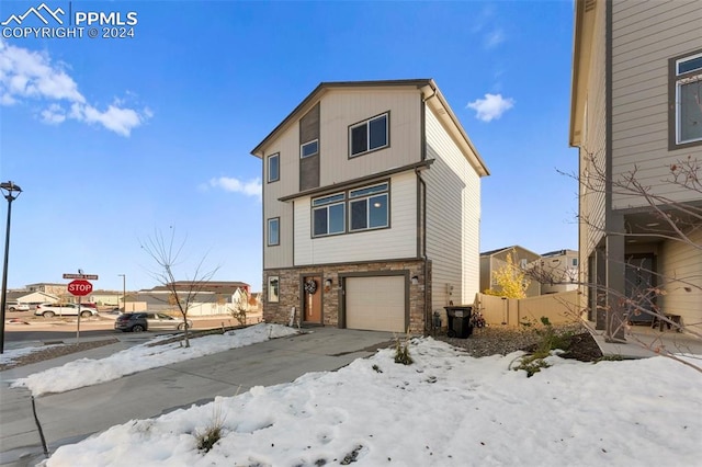 view of snowy exterior with a garage