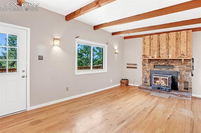 unfurnished living room with hardwood / wood-style floors and beamed ceiling