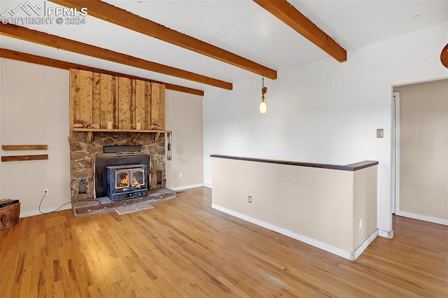 unfurnished living room with beam ceiling and hardwood / wood-style flooring